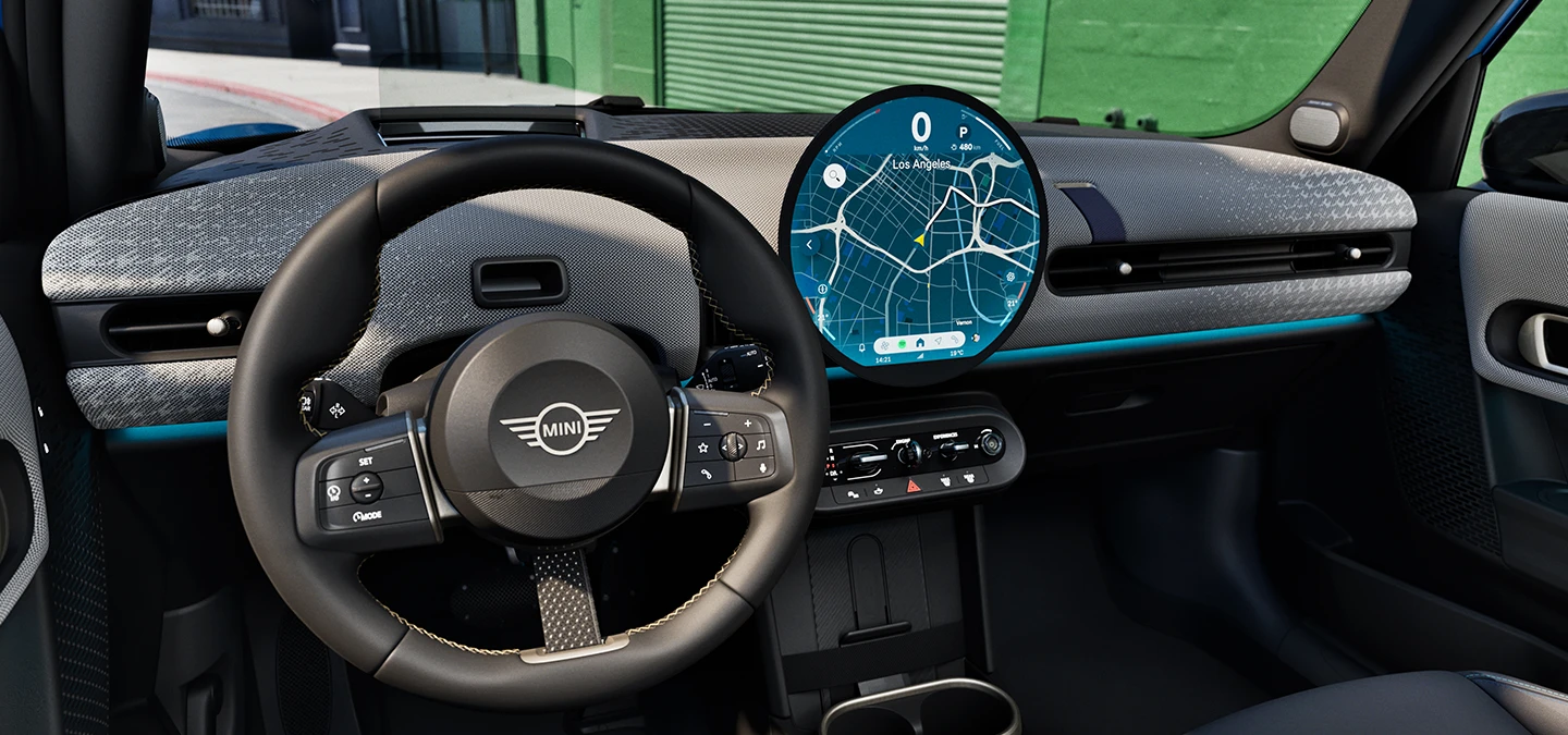 Binnenaanzicht van de MINI Cooper 5-deurs met focus op het stuur, het dashboard en de interactie-eenheid.