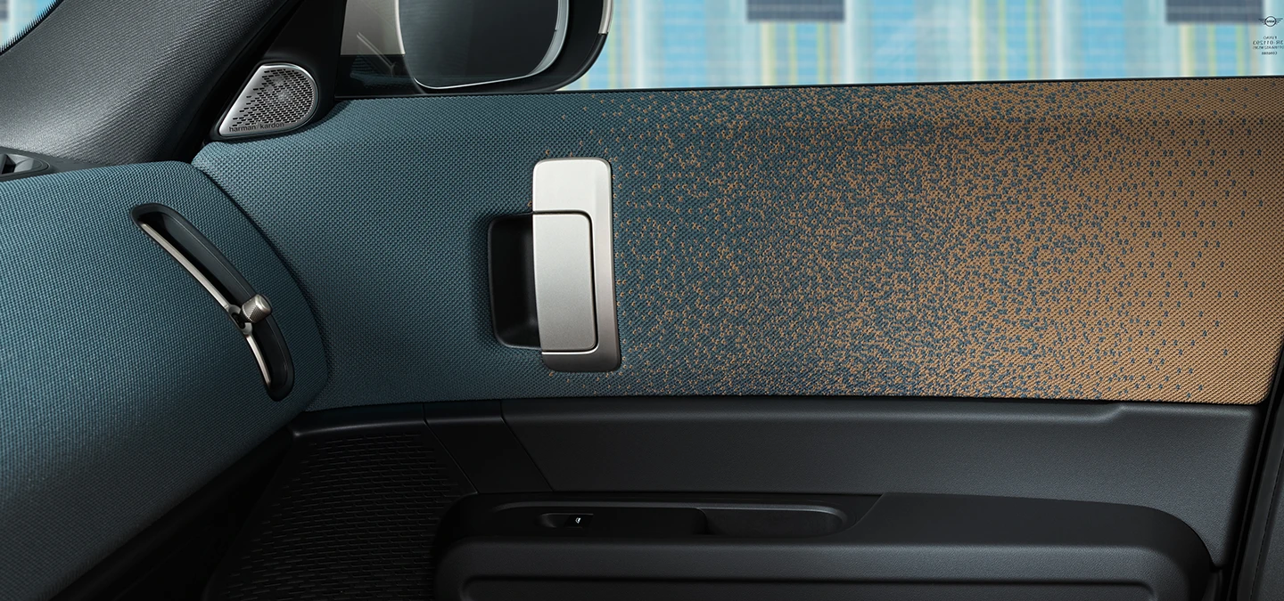 Close-up van het interieurontwerp van de MINI Countryman Electric, gericht op de deur en het dashboard.