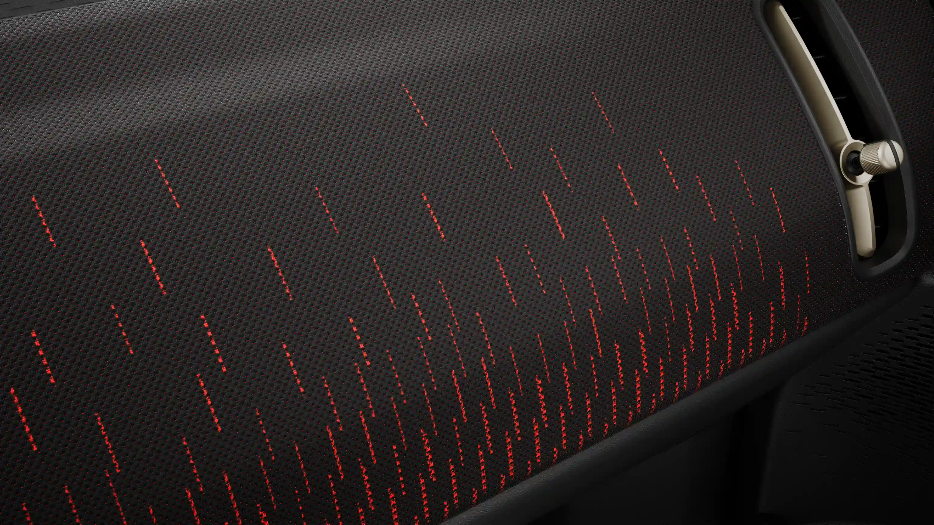 Beeld van het rood-zwarte dashboard van de volledig elektrische MINI Countryman met JCW uitvoering