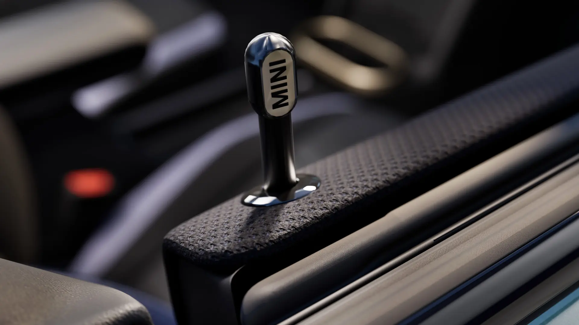 Close-up van originele MINI portiervergrendelingspen in zwart geanodiseerd aluminium.