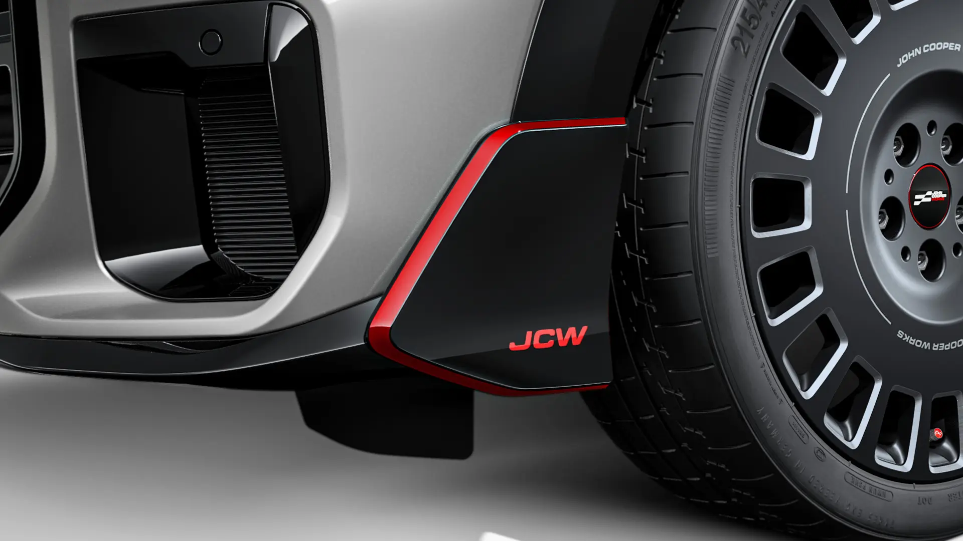 MINI John Cooper Works voorwinglet in hoogglans zwart met rood JCW opschrift en decorstrepen.